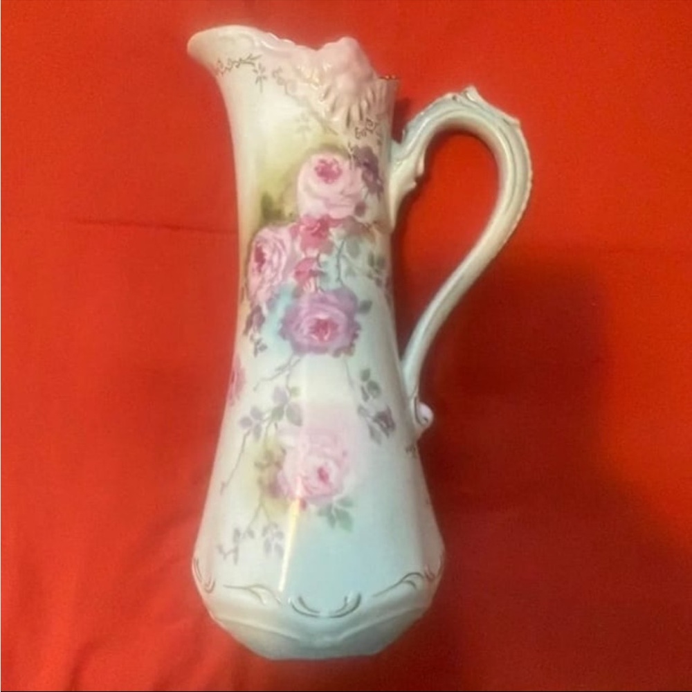 Vintage, hand-painted porcelain pitcher features clusters of pink purple roses